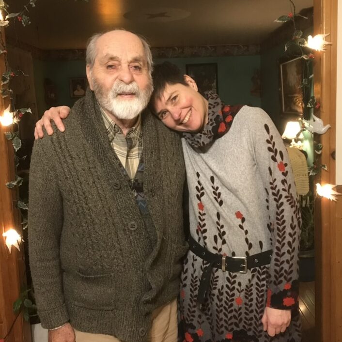 A picture of me and my dad in a doorway in his house, with my arm around him and my head on his shoulders.